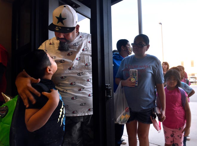Mike Calderon reassures his son Louis on his first day as a second-grader at Bonham Elementary School on Wednesday. Abilene and Wylie ISD began classes for the 2022-23 school year. Texas Education Agency campus ratings announced Monday showed Bonham improved dramatically and graded a C.