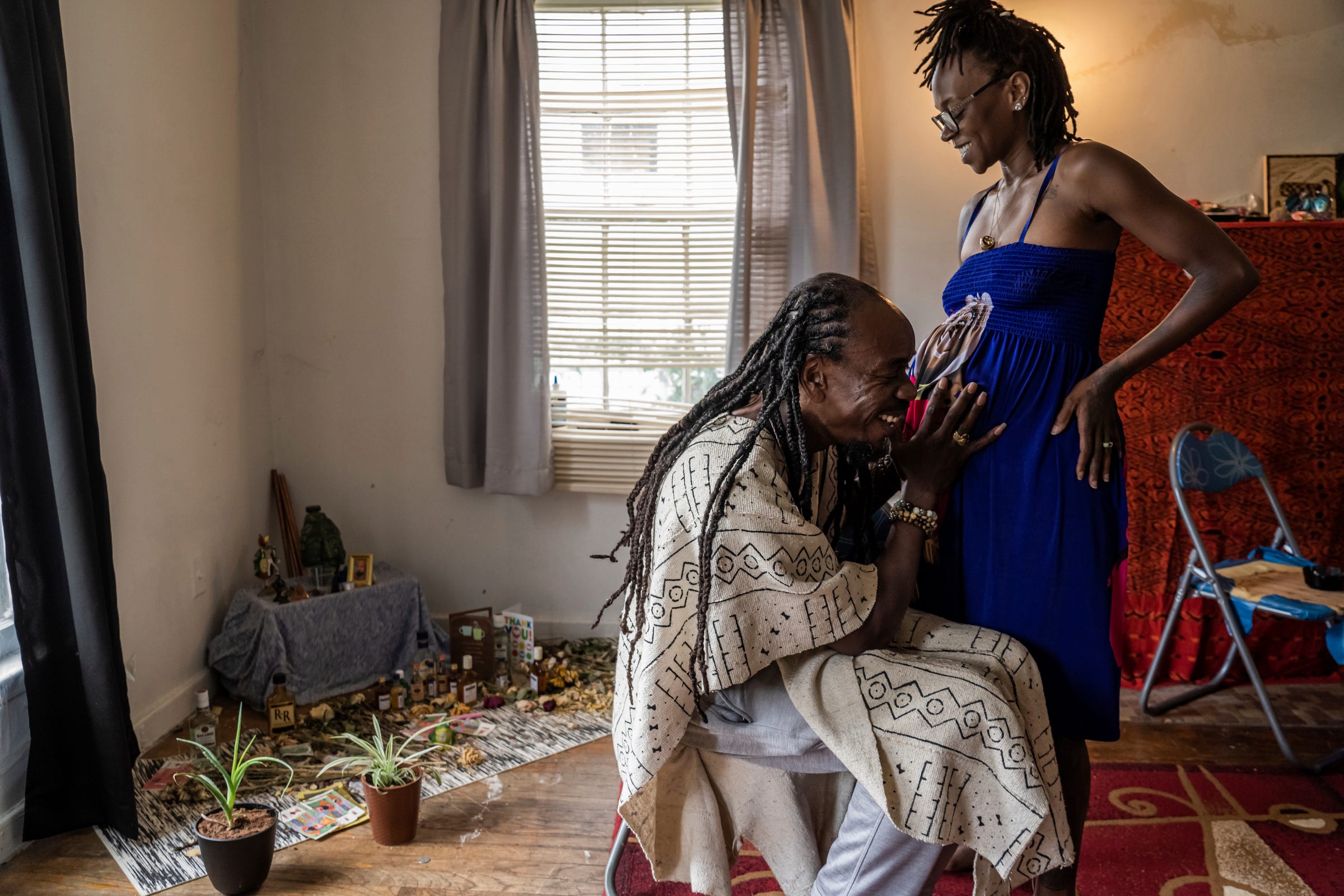 Psychonaut Academy of Detroit founder Sincere Seven, 43, touches the stomach of a pregnant Ifechi Genesis, 35, of Detroit, at the Psychonaut Academy of Detroit on Thursday, July 13, 2022.