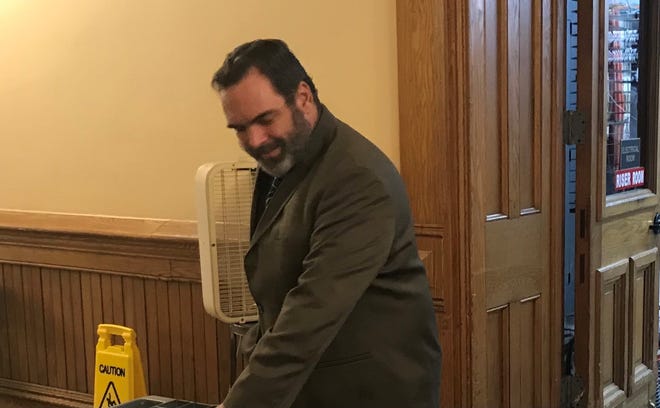 Michael Barnett passes through courthouse security on Wednesday, Aug. 17, 2022, on his way to a pre-trial hearing. Barnett and his ex-wife, Kristine Barnett, are accused of four counts of neglecting their adopted daughter, Natalia, who is a Ukrainian orphan with severe dwarfism.