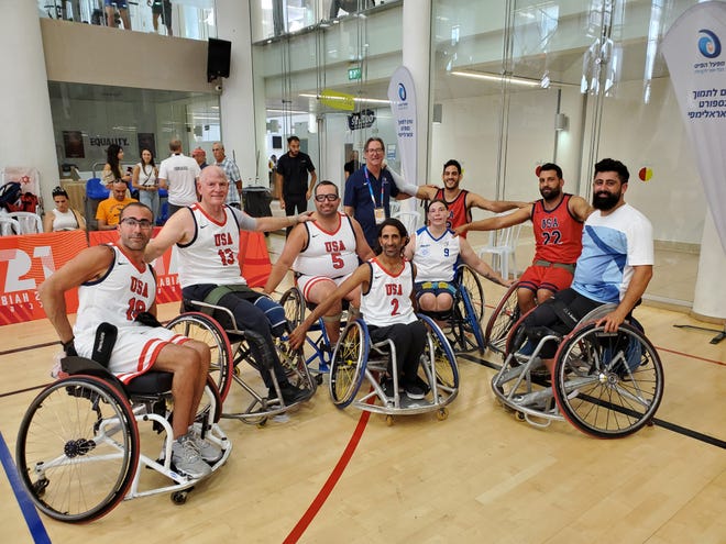 Coachella Valley resident Michael Rosenkrantz (center, in blue) poses with the wheelchair basketball team he coached at the Maccabiah Games in Israel in July 2022.