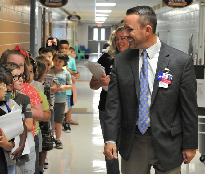 WFISD Superintendent Donny Lee smiles at Milam Elementary students as he walks the halls on the first day of school for WFISD students on Wednesday, August 17, 2022.