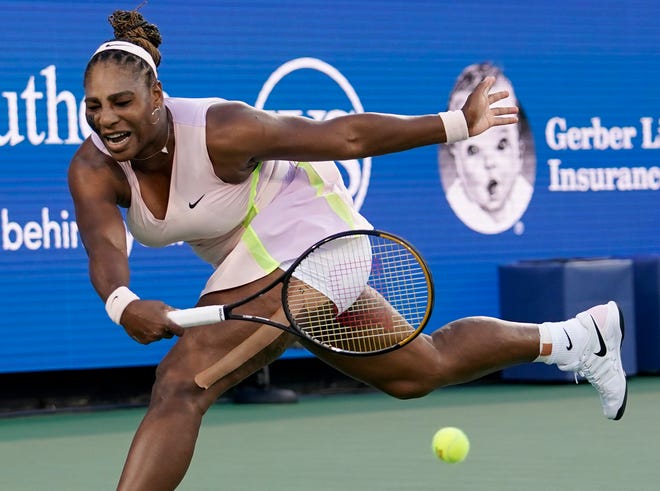 Serena Williams hits a forehand to Emma Raducanu during the Western & Southern Open.