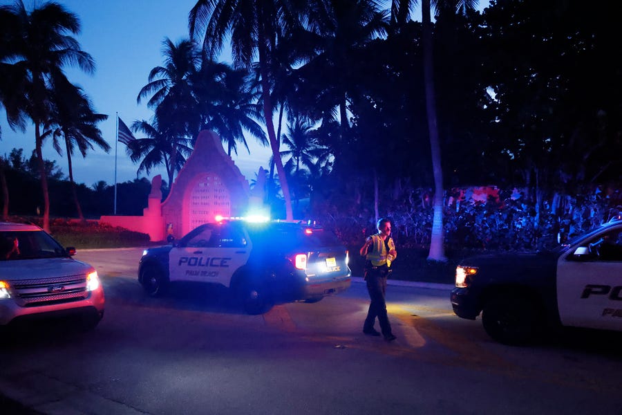 Police direct traffic outside an entrance to former President Donald Trump's Mar-a-Lago estate, Monday, Aug. 8, 2022, in Palm Beach, Fla. Trump said in a lengthy statement that the FBI was conducting a search of his Mar-a-Lago estate and asserted that agents had broken open a safe. (AP Photo/Terry Renna) ORG XMIT: FLWL406