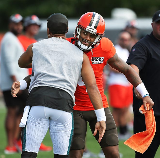 Cleveland Browns quarterback Deshaun Watson, facing, hugs Philadelphia Eagles quarterback Jalen Hurts prior to their joint practice at the Cleveland Browns training facility in Berea on Thursday.