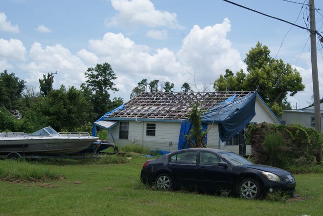 The roof of a house along La. 56 in Chauvin, damaged by Hurricane Ida, remains exposed Aug. 17, 2022.
