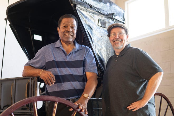 Battle Creek Regional History Museum President Doug Sturdivant and board member Michael Delaware pose for a portrait in front of a replica horse and carriage inside the Battle Creek History Museum on Wednesday, Aug. 17, 2022.