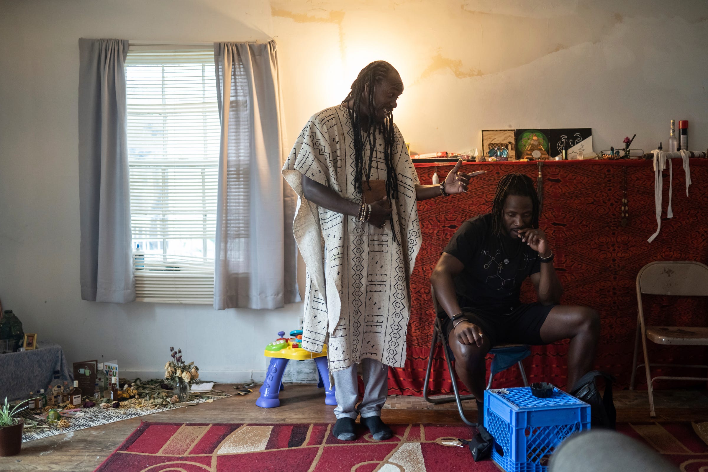 Sincere Seven, left, 43, of Detroit, talks with Brandon Parker, 42, of Detroit, as they smoke marijuana at the Psychonaut Academy of Detroit, located in an old house on the city's west side on Thursday, July 13, 2022.