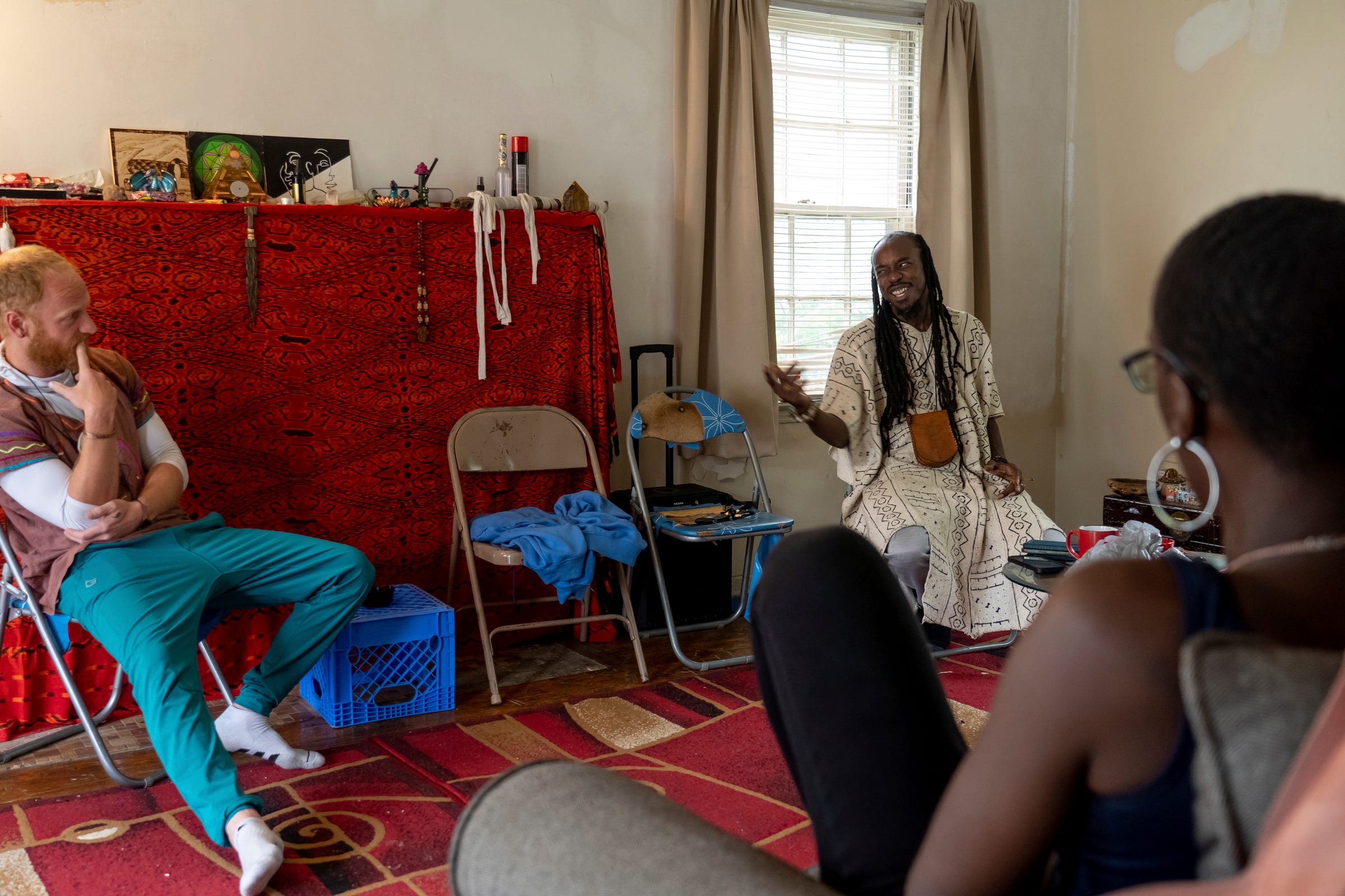 Chris LaManna, of Warren, and Psychonaut Academy of Detroit founder Sincere Seven talk with Alexis Smith, 29, of Inkster, while sitting in a room at the academy on Thursday, July 13, 2022.