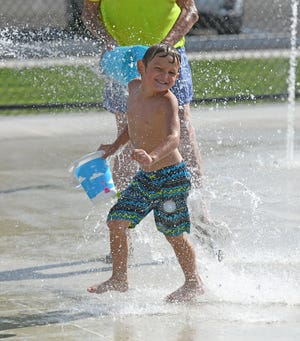 Leo Lucio, 5, enjoys the water at the new spray park in Marshall Park in Ontario on Wednesday.