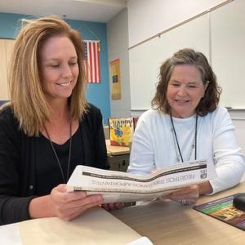 VITA/TCE volunteer Valerie Edwards, right, helps E