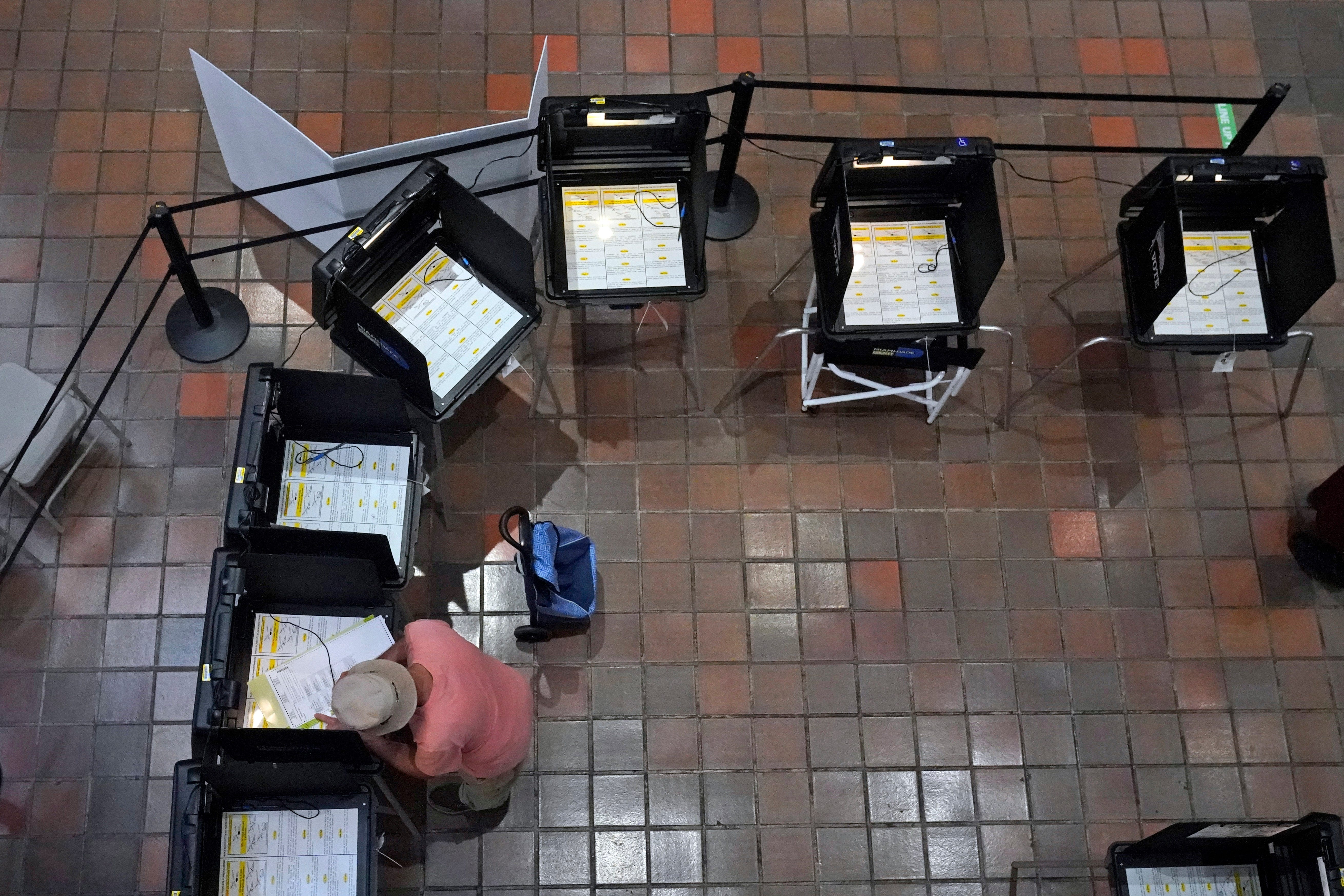 A voter fills out his ballot Aug. 8 at the Stephen P. Clark Government Center in Miami in early voting ahead of Florida's Aug. 23 primary election.