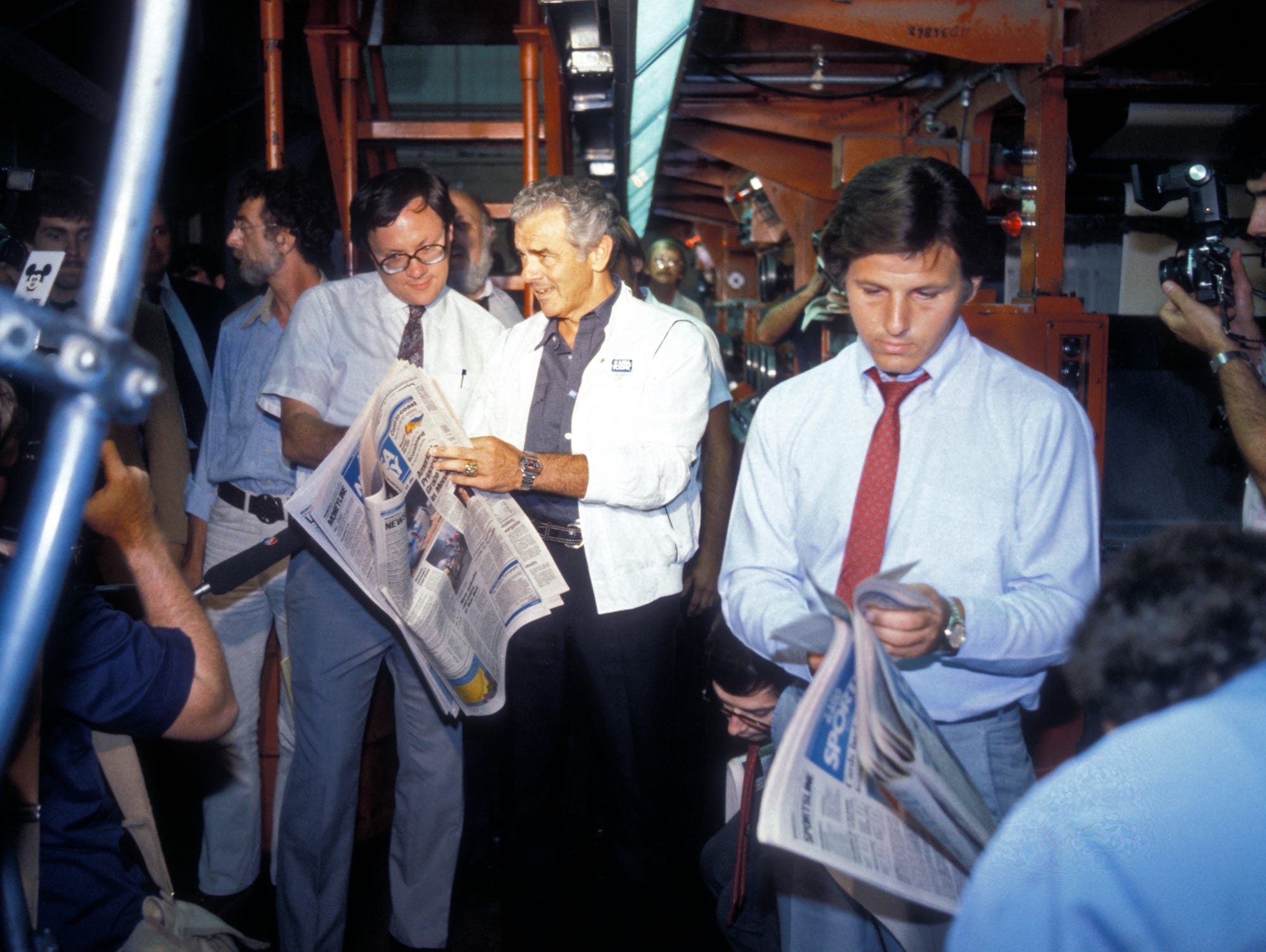 Al Neuharth, center, welcomes the first edition of USA TODAY as it rolls off the presses in Springfield, Va., on the night of Sept. 14, 1982.