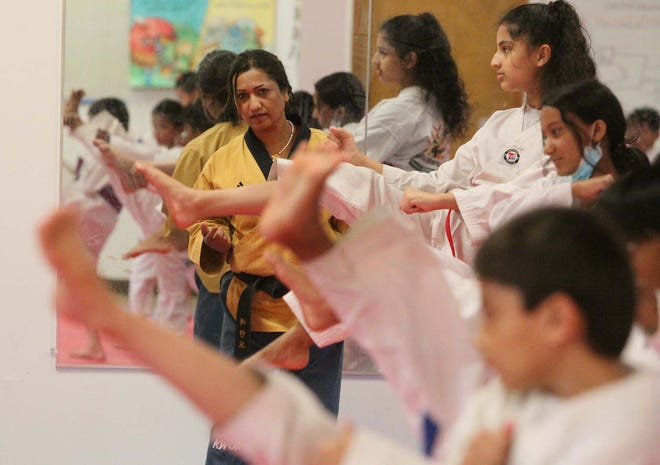 Kaushila Khanal Karmacharya, the owner of Sunshine Taekwondo Academy, leads a class  in Akron.