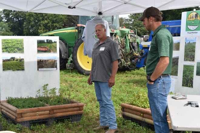 Scott Schultz, left, a Jefferson County Farm Bureau Board member and Brendon Blank a cover crops consultant with Jefferson County Soil Builders, speak on nutrient stewardship and the use of cover crops during a field day at Taglane Dairy in Ixonia, Wis.