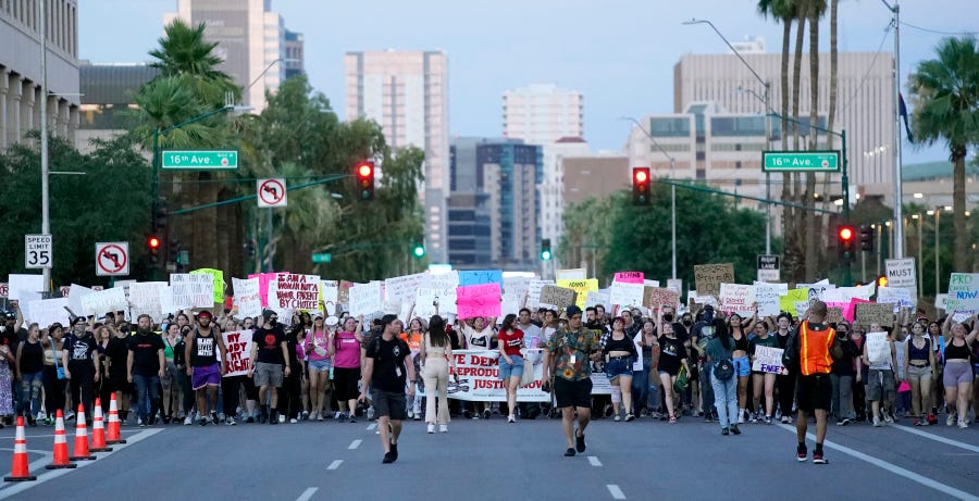 Thousands of protesters march around the Arizona Capitol after the Supreme Court decision to overturn the landmark Roe v. Wade abortion decision Friday, June 24, 2022, in Phoenix.