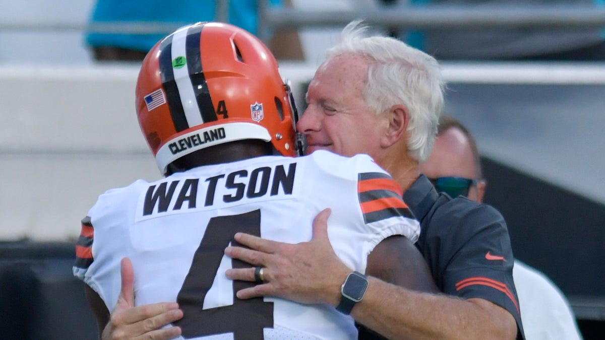 Cleveland Browns owner Jimmy Haslam talks with quarterback Deshaun Watson on the sideline before the team's NFL preseason football game against the Jacksonville Jaguars on Aug. 12, 2022, in Jacksonville, Fla. Watson will serve an 11-game unpaid suspension, pay a $5 million fine and undergo professional evaluation and treatment as part of a settlement with the NFL following accusations of sexual misconduct by two dozen women.