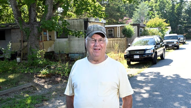 Residents Association board member Albert MacDonald at the Pocasset Mobile home park in August. The association wants to buy the park. Standing near his residence on Third Avenue, he said the park's association ownership might allow for improvements.