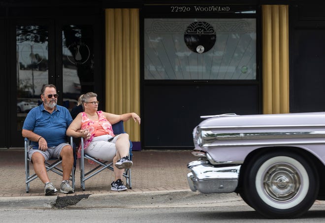 Jim Gnacke, left, stands next to his girlfriend of 24 years, Debbie Roy, during the Woodward Dream Cruise 2022 in Ferndale on Saturday, Aug. 20, 2022.