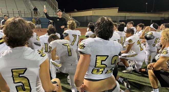 Defensive coordinator Marty Freel talks to the Oak Park team after the Eagles defeated host Buena 33-21 in a season-opening game on Friday night.