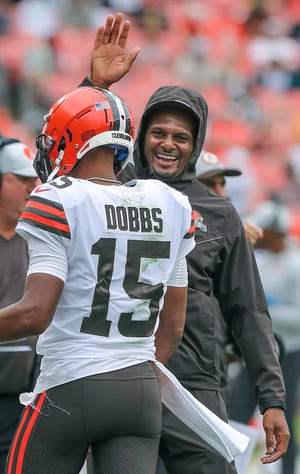 Browns quarterback Josh Dobbs gets a pat on the head from Deshaun Watson after scoring against the Eagles, Sunday, Aug. 21, 2022 in Cleveland.