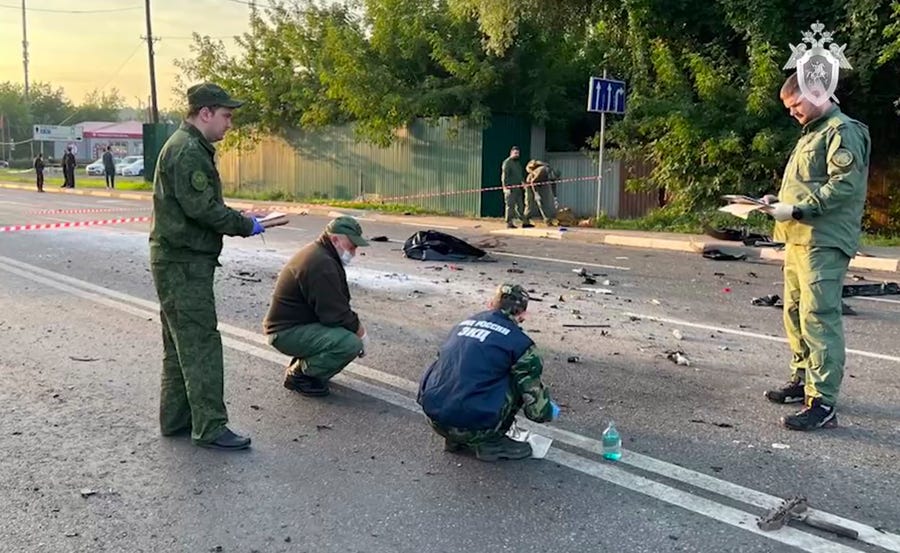 In this handout photo taken from video released by Investigative Committee of Russia on Sunday, Aug. 21, 2022, investigators work on the site of explosion of a car driven by Daria Dugina outside Moscow. Daria Dugina, the daughter of Alexander Dugin, the Russian nationalist ideologist often called "Putin's brain", was killed when her car exploded on the outskirts of Moscow, officials said Sunday. The Investigate Committee branch for the Moscow region said the Saturday night blast   was caused by a bomb planted in the SUV driven by Daria Dugina. (Investigative Committee of Russia via AP) ORG XMIT: XDL101