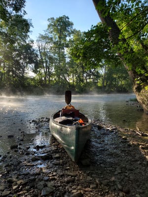 Getting ready to break camp in the morning, while the mist is still dancing on the river.