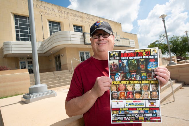 Keith Van Sickle, creator of the Slash and Bash Film Festival, holds his event poster in front of the Topeka Performing Arts Center. The two-day film festival is going into its 18th year.