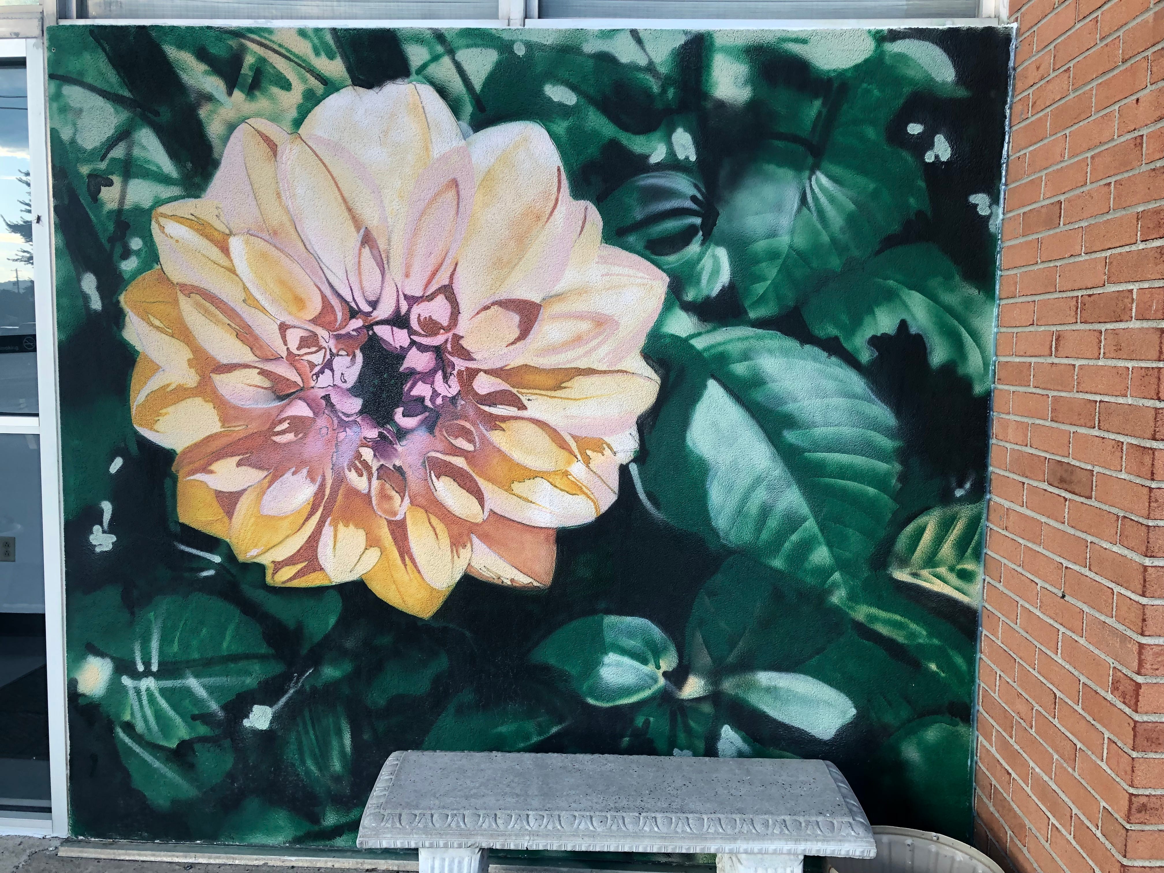 A dahlia is painted outside of Southern Tier Women's Health Services at 149 Vestal Parkway W. in Vestal. Artist Bruce Greig completed the piece in 2020.