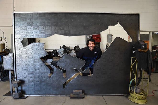 Artist Simon Bellamy poses with his art piece titled "Sallie Gardener" that he built at The Generator in Sparks. His art piece is part of the Wild Horses of the American West project, a 2022 Black Rock City honoraria recipient.