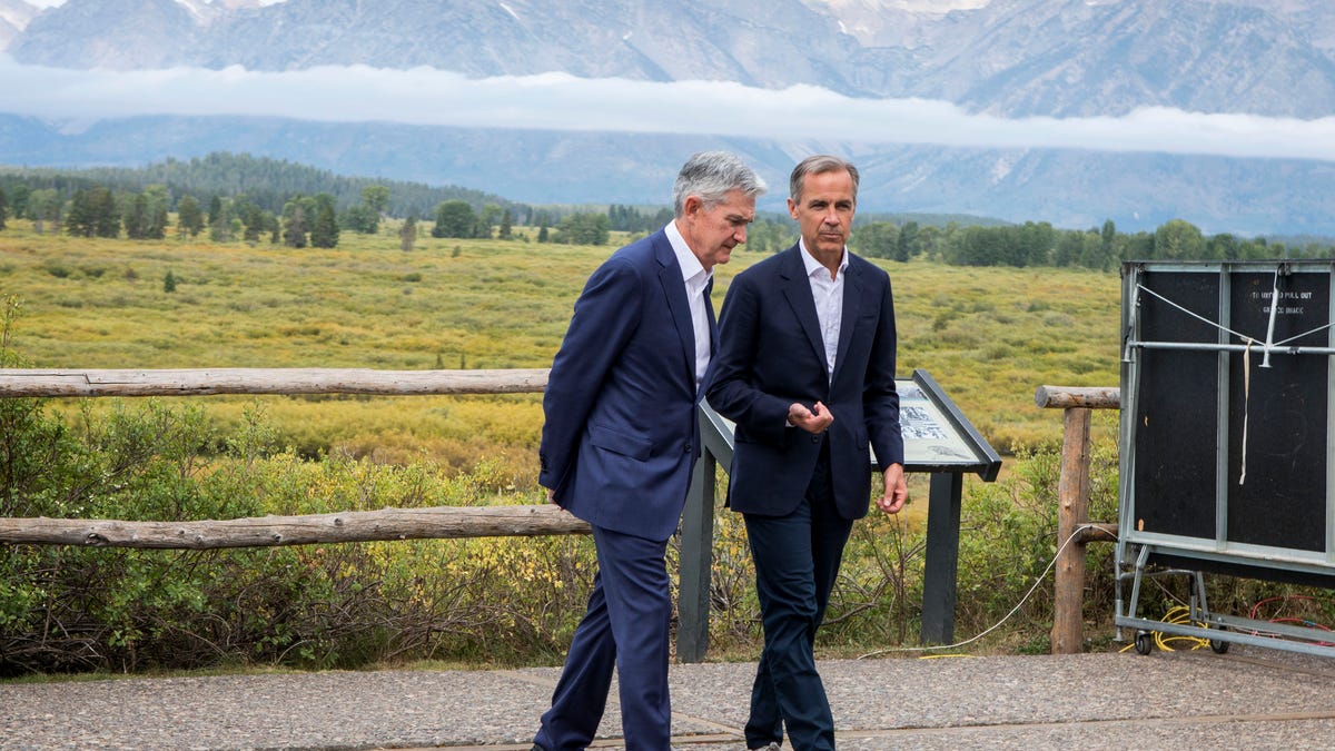 Jerome Powell, Chairman of the Board of Governors of the Federal Reserve System, left, and Bank of England Governor Mark Carney, right, walk together after Powell's speech at the Jackson Hole Economic Policy Symposium on Friday, Aug. 23, 2019, in Jackson Hole, Wyo. (AP Photo/Amber Baesler) ORG XMIT: WYJC110 [Via MerlinFTP Drop]