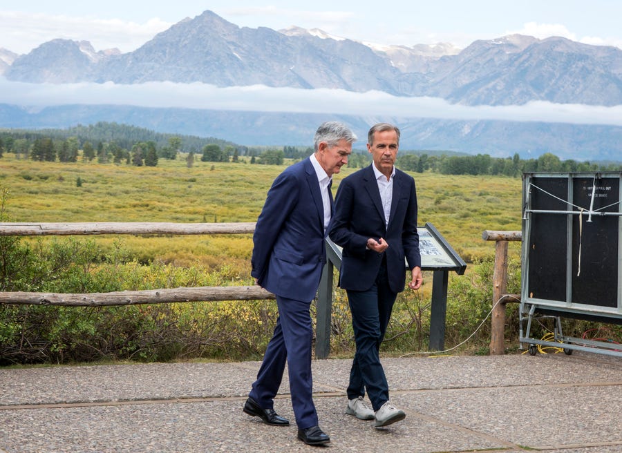 Jerome Powell, Chairman of the Board of Governors of the Federal Reserve System, left, and Bank of England Governor Mark Carney, right, walk together after Powell's speech at the Jackson Hole Economic Policy Symposium on Friday, Aug. 23, 2019, in Jackson Hole, Wyo. (AP Photo/Amber Baesler) ORG XMIT: WYJC110 [Via MerlinFTP Drop]