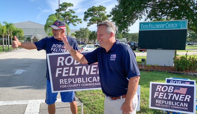 Rob Feltner, right, candidate for County Commission in District 4 outside Precinct 427, at Faith Fellowship Church in Melbourne.