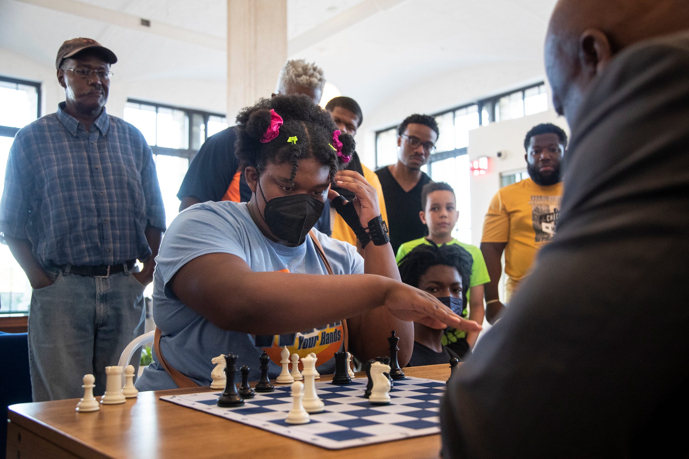 Charisse Woods, 17, a member of Detroit Chess Club, plays blitz chess with grandmaster Maurice Ashley at WeWork offices in Detroit on Friday, August 19, 2022. Ashley earned the grandmaster title in 1999 as the first African American to do so.