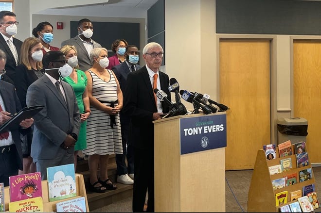 Gov. Tony Evers announces a proposal to tap a state revenue surplus to enact tax cuts during an appearance Tuesday, Aug. 23, 2022, at Malaika Early Learning Center in Milwaukee.  