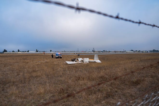 Wreckage from a plane crash lies in a field at Watsonville Municipal Airport in Watsonville, Calif., Thursday, Aug. 18, 2022. (AP Photo/Nic Coury)
