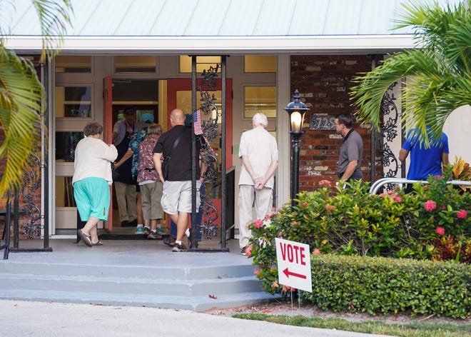 A line of Martin County voters wait to vote in the Florida primary election Tuesday, Aug. 23, 2022, at the Woman's Club of Stuart. 