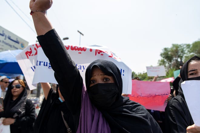 Taliban fighters fired into the air as they dispersed a rare rally by women as they chanted "Bread, work and freedom" and marched in front of the education ministry building, days ahead of the first anniversary of the hardline Islamists' return to power, on August 13, 2022 in Kabul, Afghanistan.