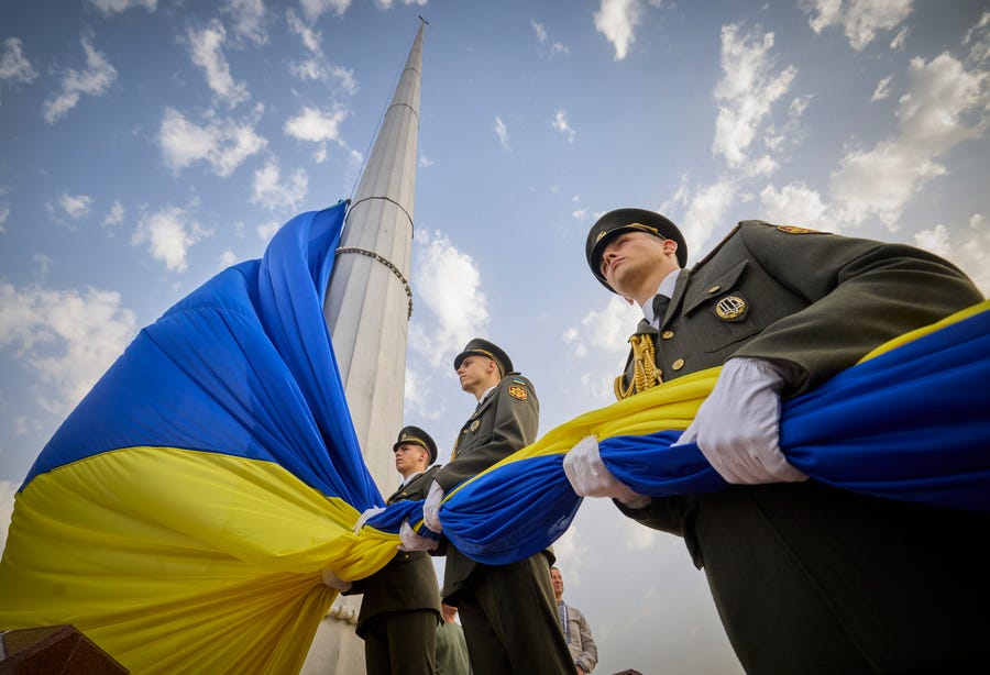 In this photo provided by the Ukrainian Presidential Press Office, honour guard soldiers prepare to rise the Ukrainian national flag during State Flag Day celebrations in Kyiv, Ukraine, Tuesday, Aug. 23, 2022.