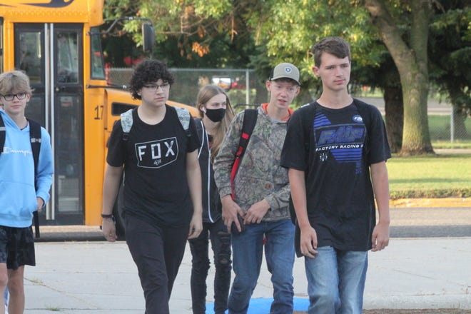 Students walk toward the entrance of Devils Lake High School (DLHS) on the first day of school.