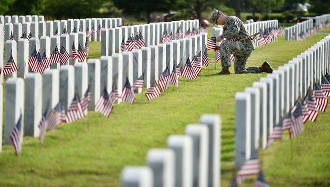 Ahead of Memorial Day 2022, Navy Aviation Electricians Mate Blaine Click was among hundreds of military members, veterans, family and community members who helped place small American flags at each of the 22,000 veteran headstones at Jacksonville National Cemetery.