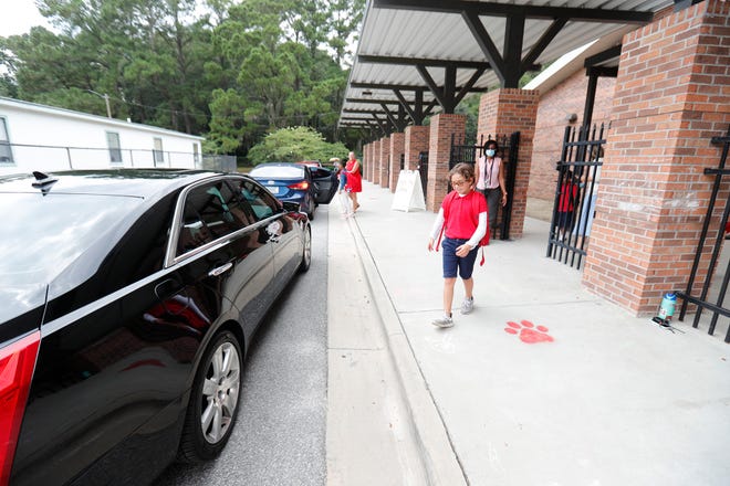 Gisele Dillard walks to her mom's car in the pickup line at Largo-Tibet Elementary.