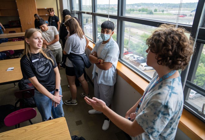 Peyton Clark, 17, Joshua Gonzalez, 16, and Dayton Fleenor, 17, discuss financial questions as Tim Brickley teaches a class on investment and real estate at Central Campus in Des Moines, Wednesday, Aug. 24, 2022.