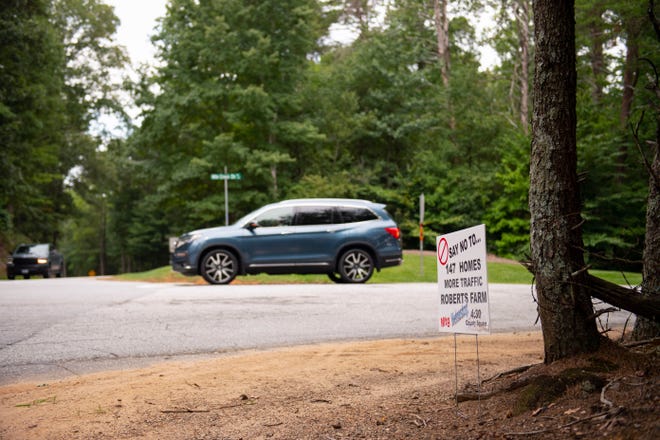 A sign opposing Robert's Farm development is seen at the intersection of East Mountain Creek Road and Mountain Creek Church Road, at the edge of the property where the development is set to be built in the Pebble Creek neighborhood in Taylors on Wednesday, August 24, 2022. 
