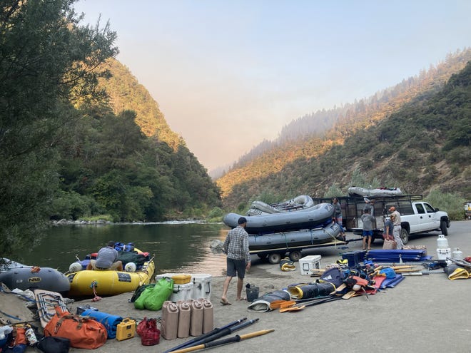 Indigo Creek Outfitters guides gear up for a multiday trip on the Rogue River after fire crews reopened the river as the Rum Creek Fire makes the sky slightly smoky.