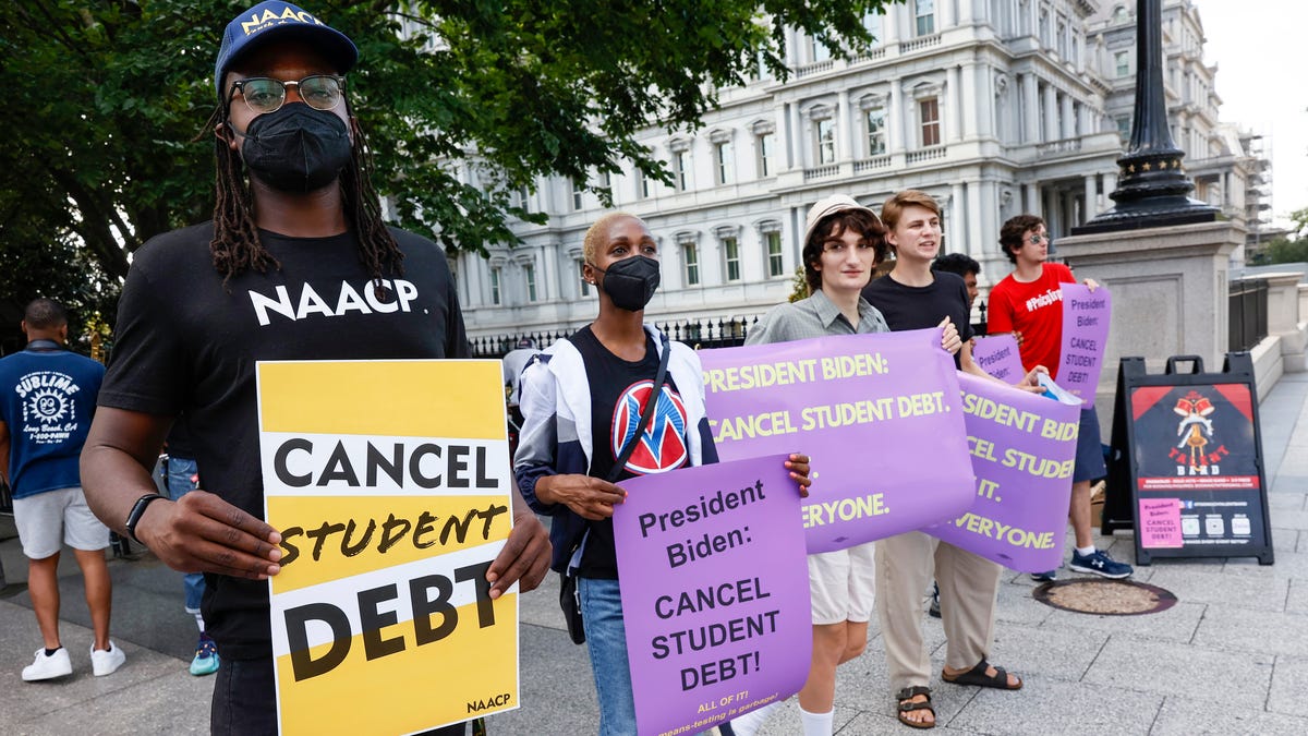 Student loan debt holders protest outside the White House staff entrance on July 27, 2022, in Washington, D.C.