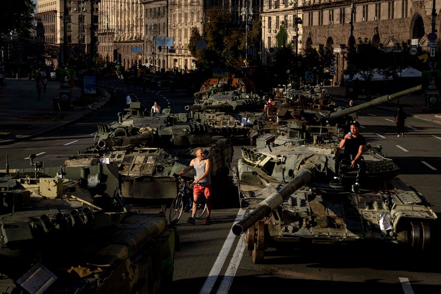 People walk around destroyed Russian military vehicles installed in downtown Kyiv, Ukraine, for the country's Independence Day on Wednesday, Aug. 24, 2022. Kyiv authorities have banned mass gatherings through Thursday for fear of Russian missile attacks. Wednesday also marked six months since the Russian invasion began.