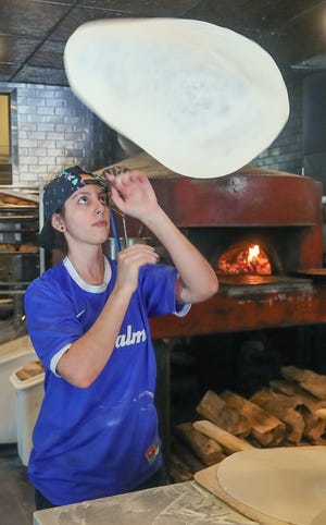 Erica Chiera hand-tosses pizza dough at 3 Palms Pizzeria & Bakery in Hudson.
