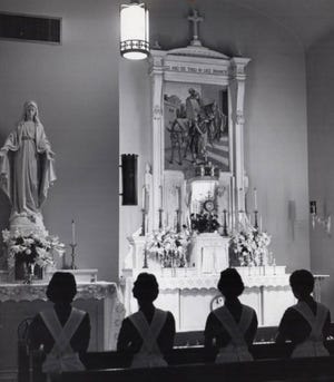Student nurses take a break from classes in 1961 to pray in the chapel at St. Thomas Hospital in Akron.