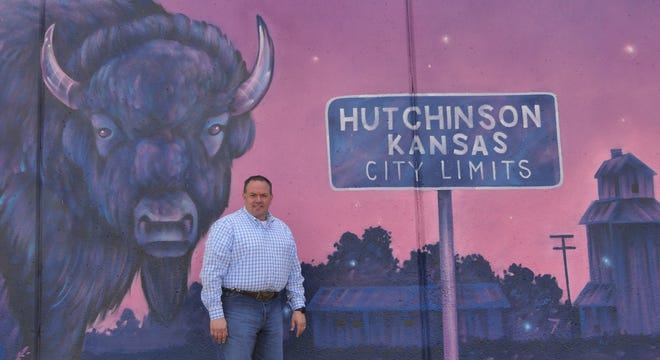 Kansas State Fair General Manager Bryan Schulz stands in front of the new mural at the fair.