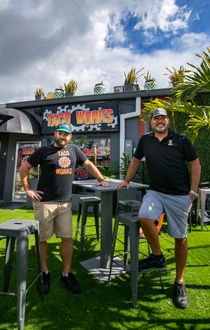 Co-owners of Taco Works in Downtown Cape Coral Max Curtis, left, and Ozzie Morrobel pose in front of their restaurant Wednesday, August 24, 2022.